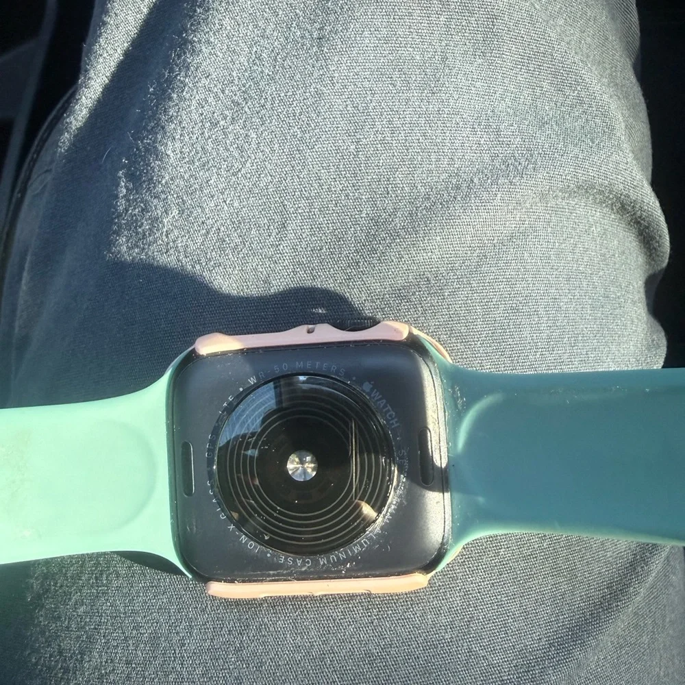Smartwatch with Teal Band and Peach Case - Apple Watch